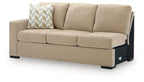 Almond left-arm facing sofa with three back cushions, patterned pillow, and black legs