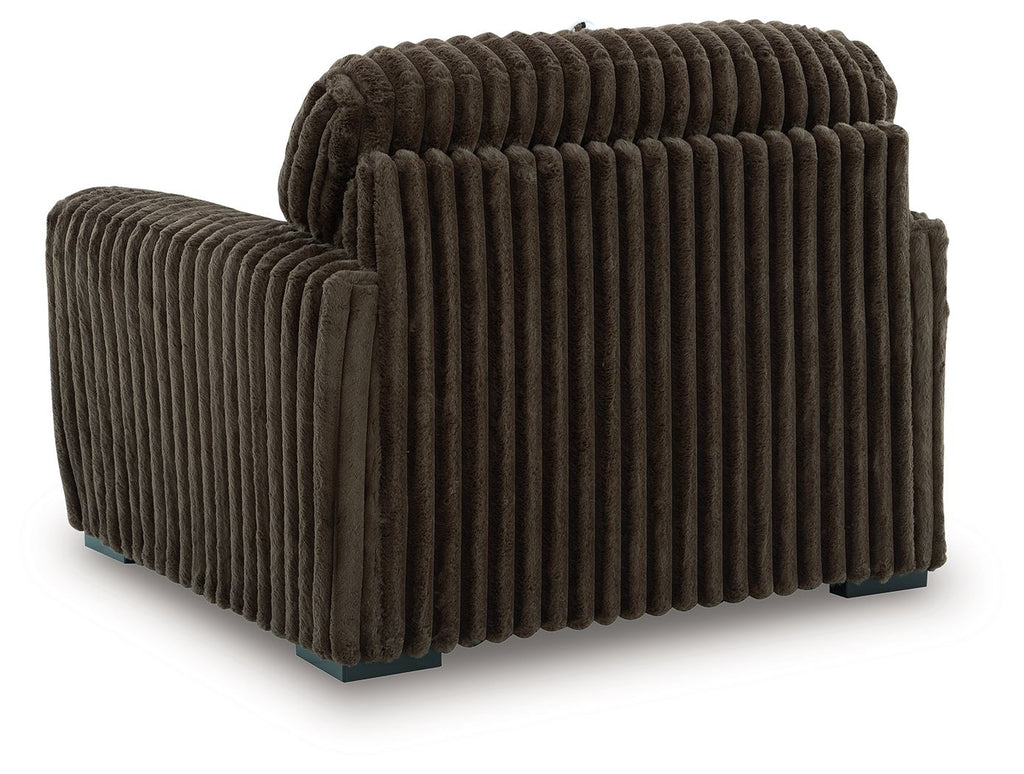 Dark brown chair and a half with thick ribbed upholstery and rounded arms