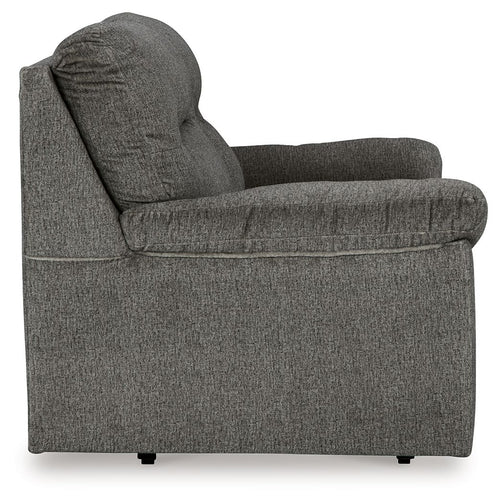 Glider loveseat side view, dark gray fabric with rounded arms and thick back cushion