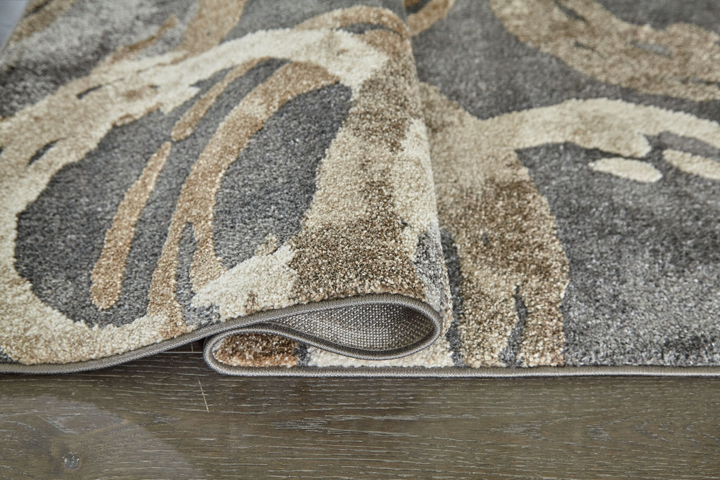 Faelyn rug edge with low pile and gray, cream, and tan abstract swirl design