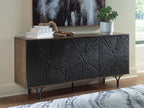 Low cabinet with dark embossed starburst front, wood sides, tapered metal legs.