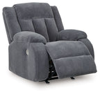 Fabric power rocker recliner in dark steel-gray, footrest raised, padded arms