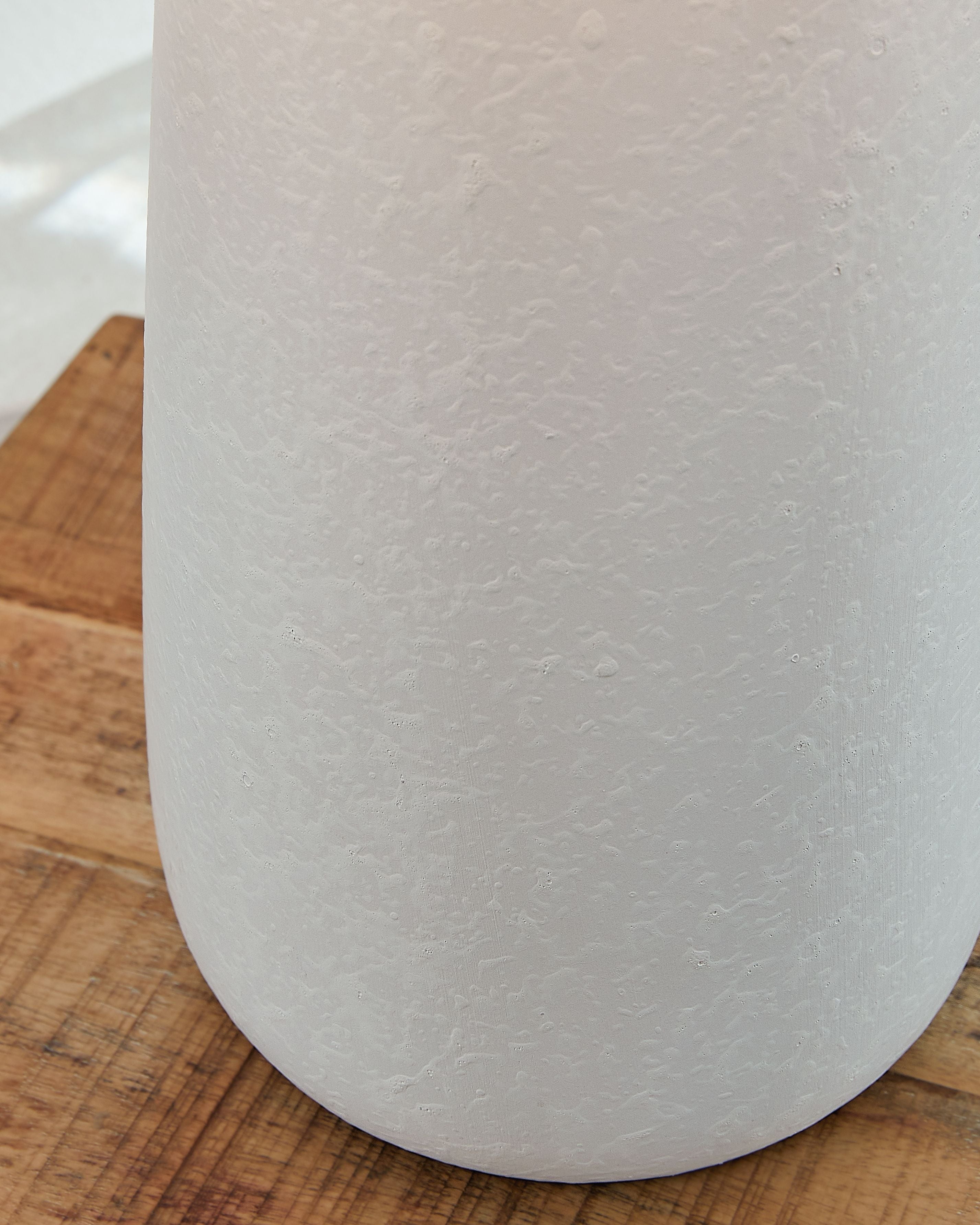 Ceramic lamp base with subtle speckled texture and rounded bottom