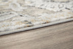 Gray and cream area rug edge with low pile and fringe-free border