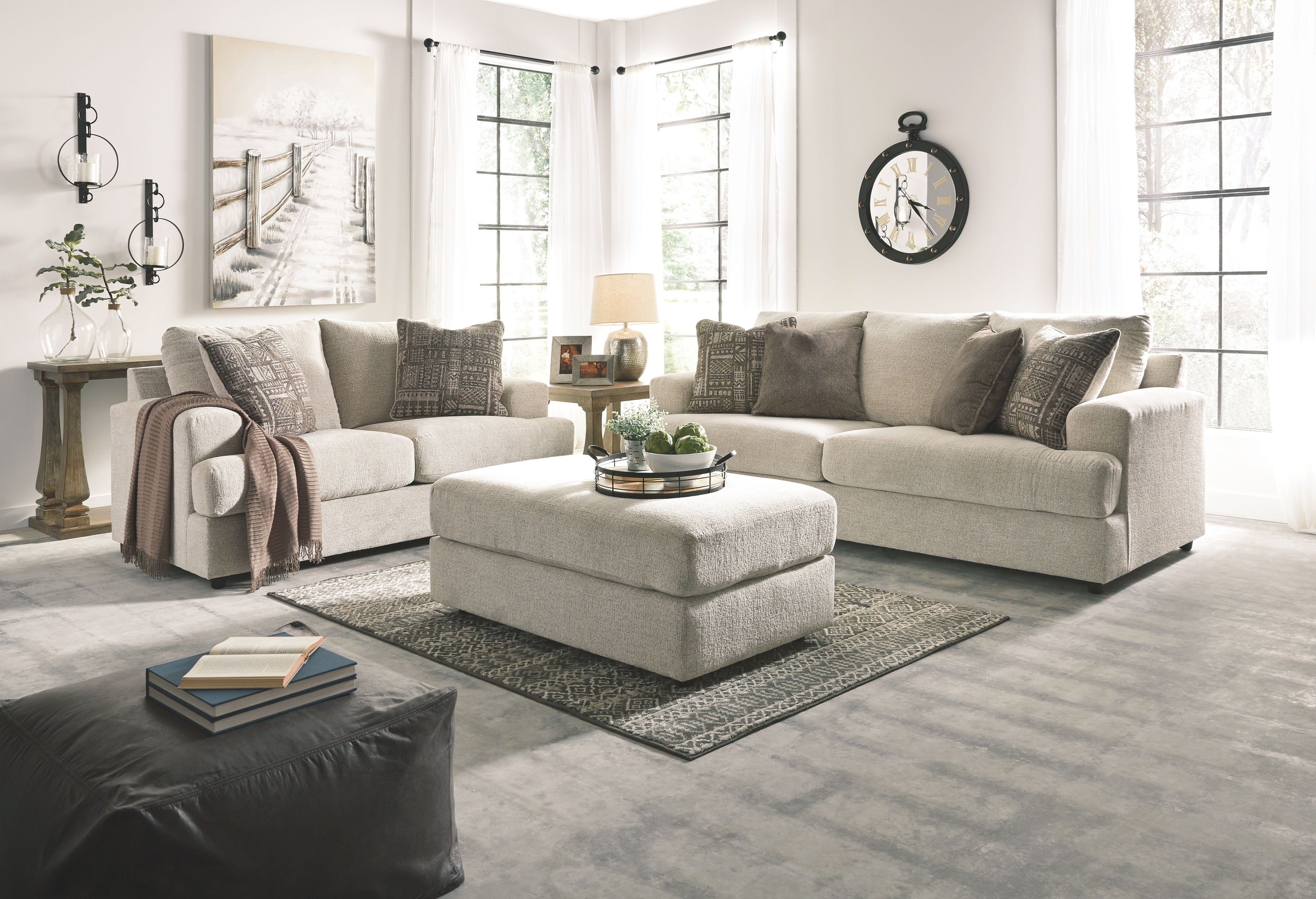 Beige fabric living room sofa set with ottoman and decorative throw pillows