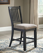 Two-tone barstool with vertical slatted back and cushioned light-gray seat, dark frame