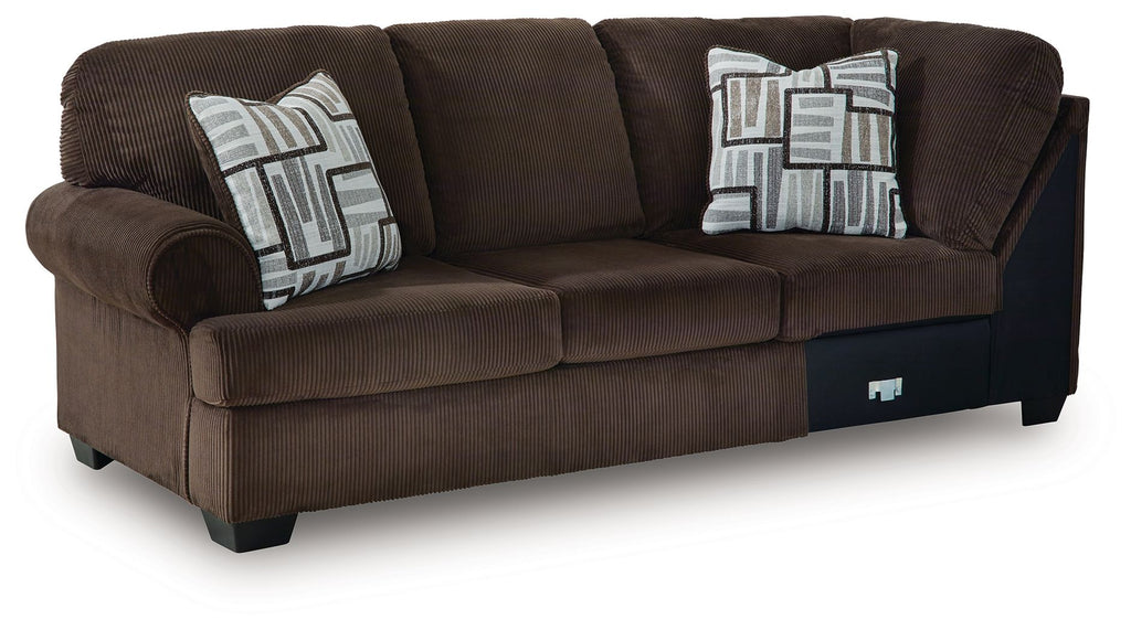 Dark brown corner wedge sectional sofa with two cushions and patterned throw pillows