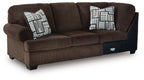 Dark brown corner wedge sectional sofa with two cushions and patterned throw pillows