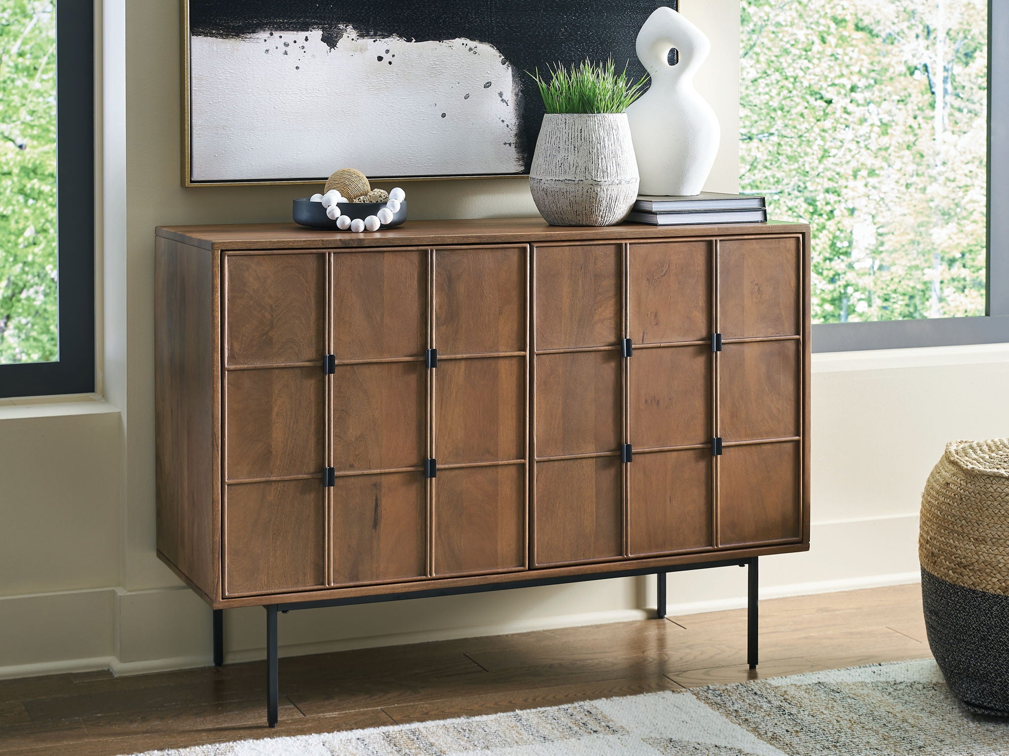 Brown accent cabinet with multiple door sections and black knobs, side view