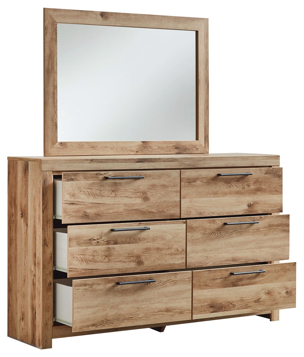 Tan wood dresser with framed mirror and stacked six drawers, black bar pulls