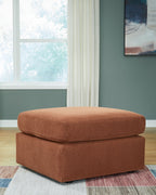 Brown accent ottoman with cushioned top and square base, dark feet.