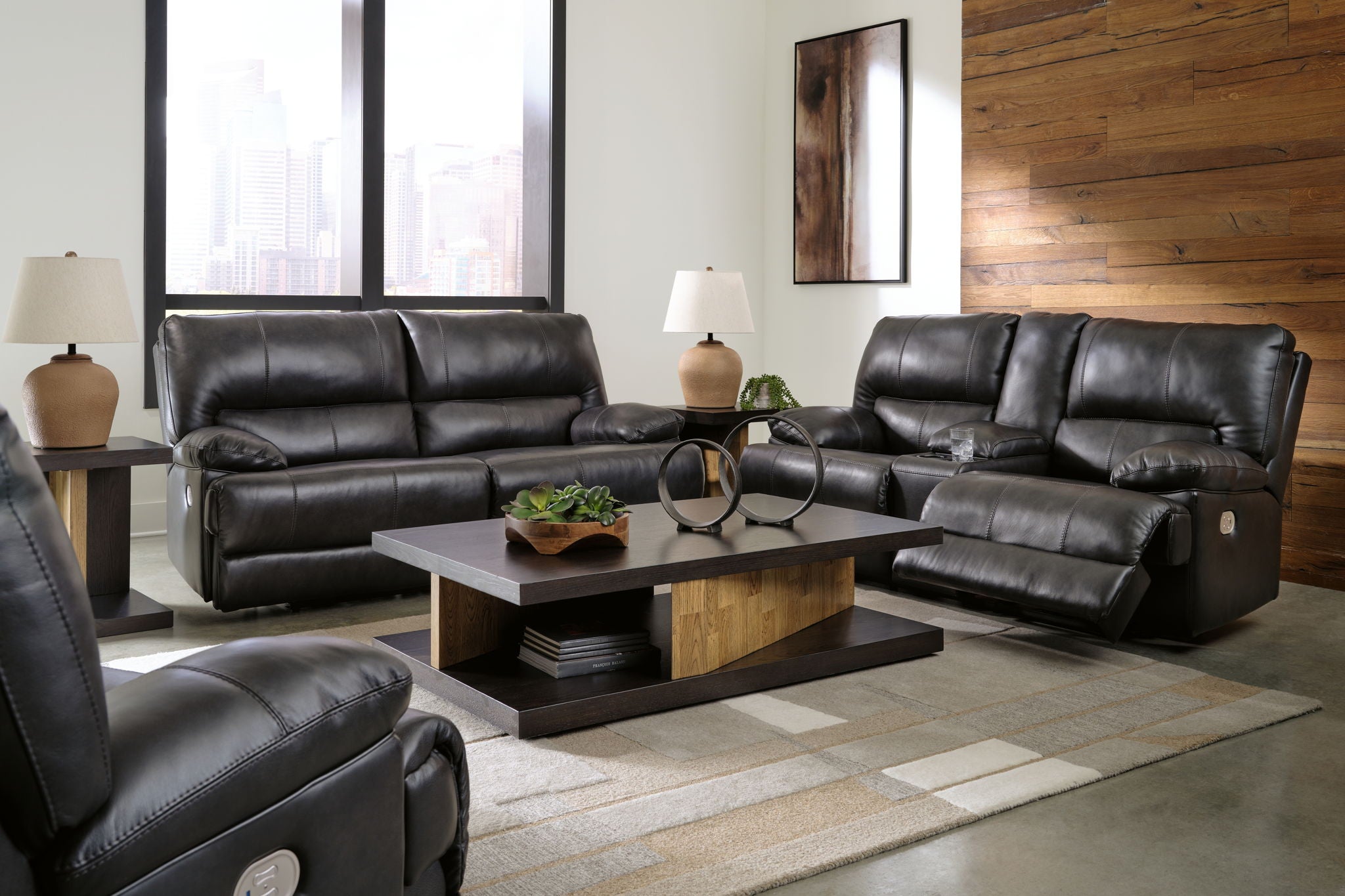 Black leather-look seating set with sofa, loveseat, and recliner-style seats
