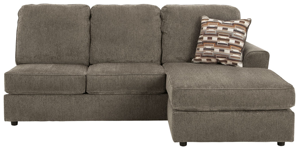 Gray sofa chaise with deep seat cushion and patterned throw pillow on arm