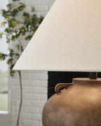 Antique beige poly table lamp showing fabric drum shade and textured base