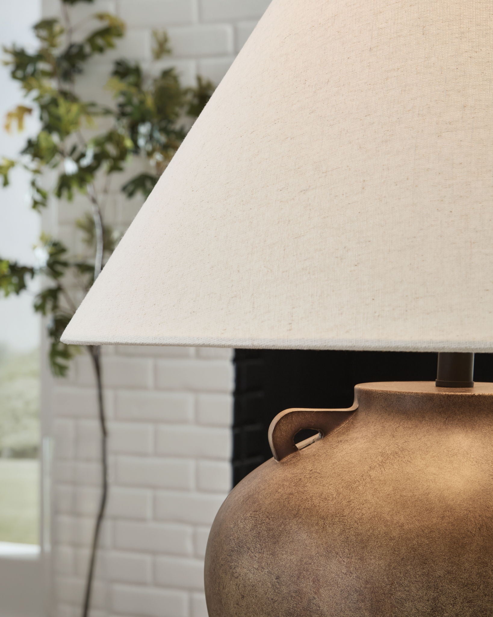 Antique beige poly table lamp showing fabric drum shade and textured base