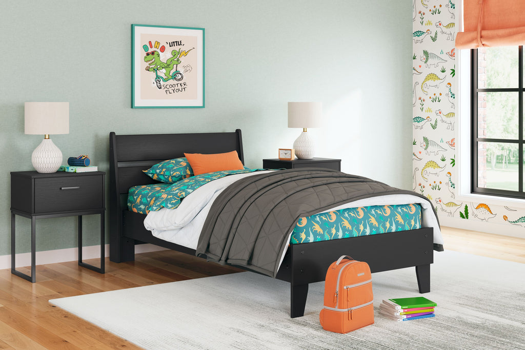 Black panel platform bed with colorful bedding and white pillow
