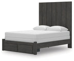 Dark gray panel storage bed frame with white mattress and two pillows, side view