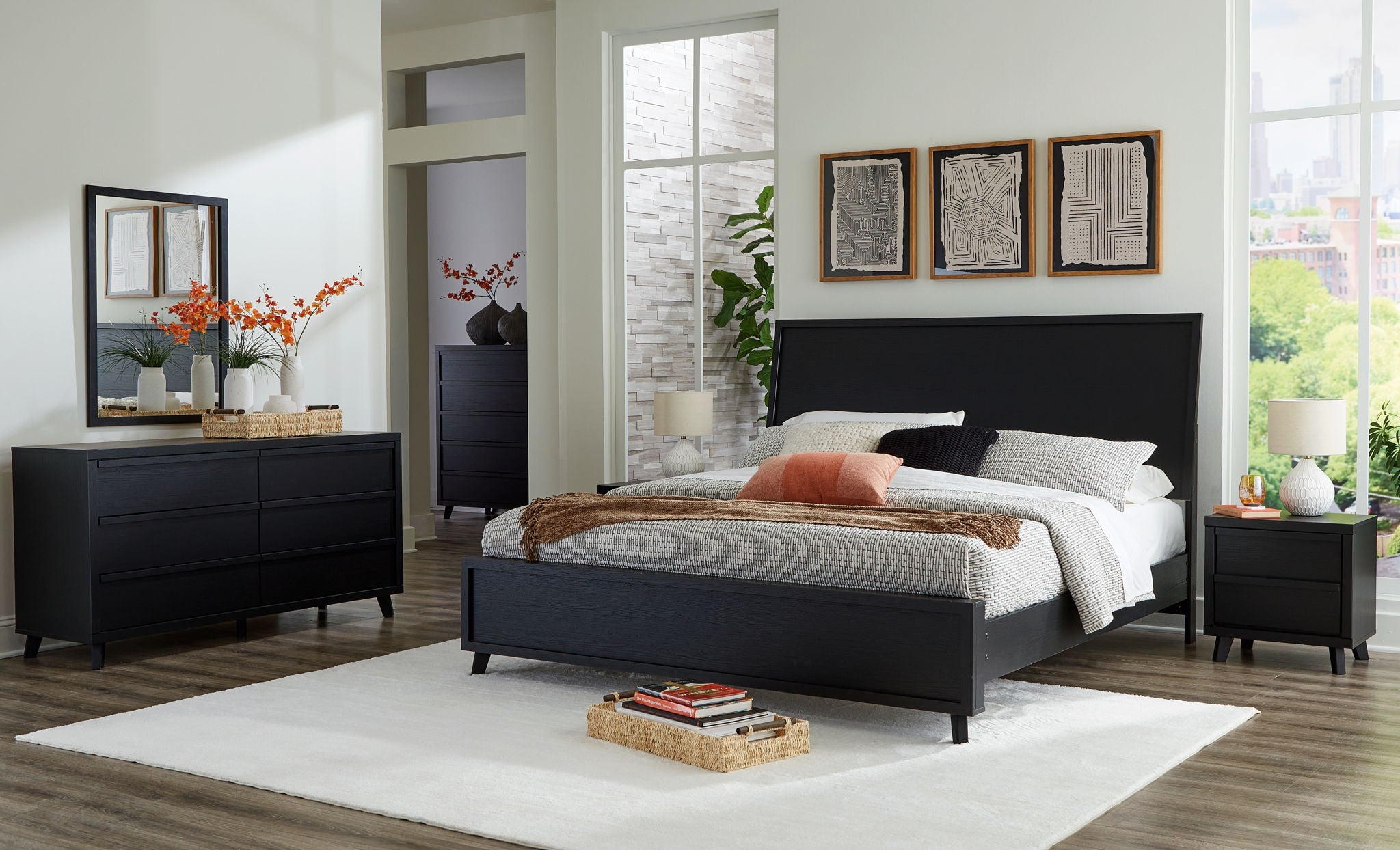 Black panel bedroom set with bed, dresser, mirror, and two nightstands