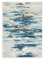 Washable area rug with abstract blue cloud pattern on light cream background