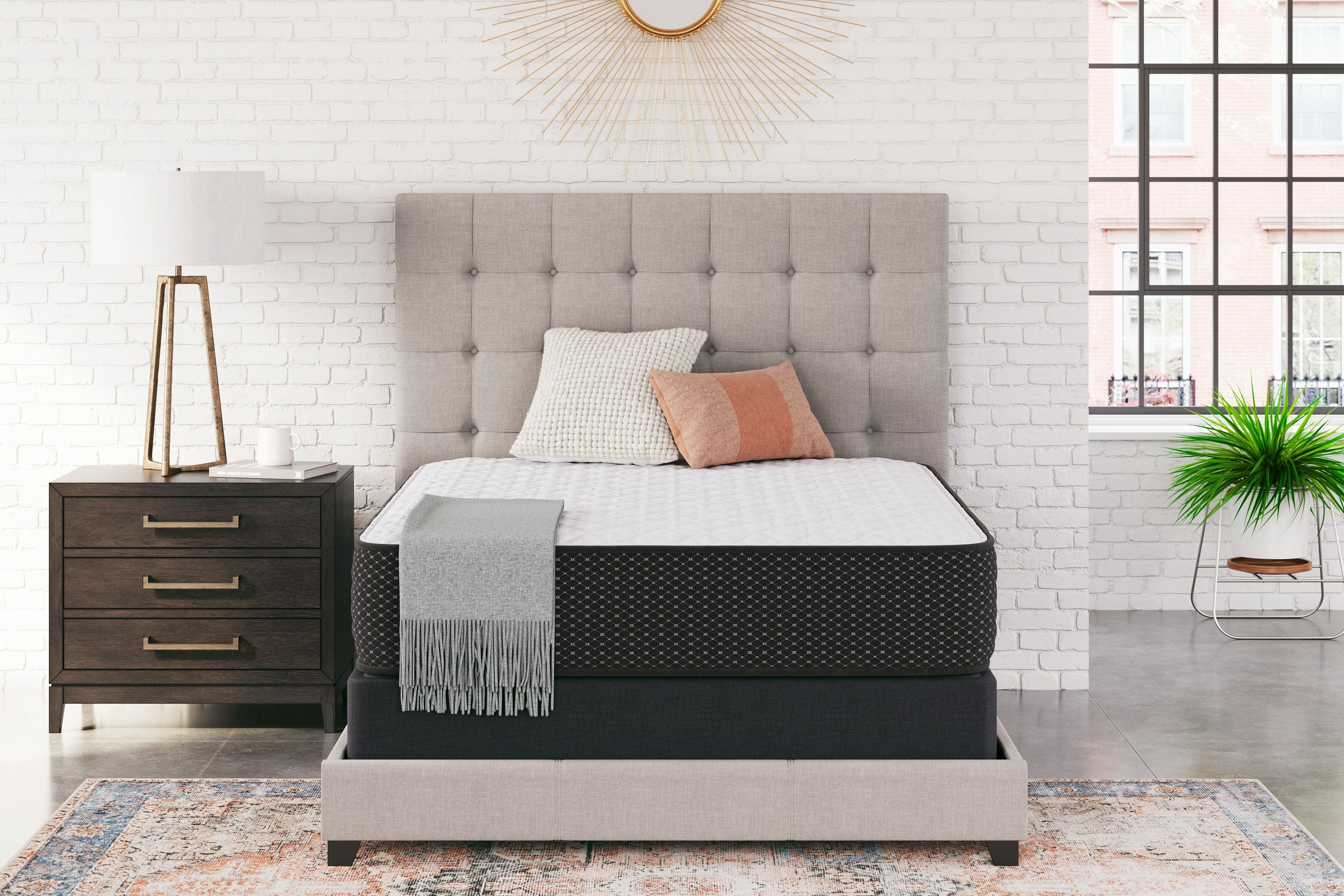 Firm mattress on bed frame with white top and black side panels