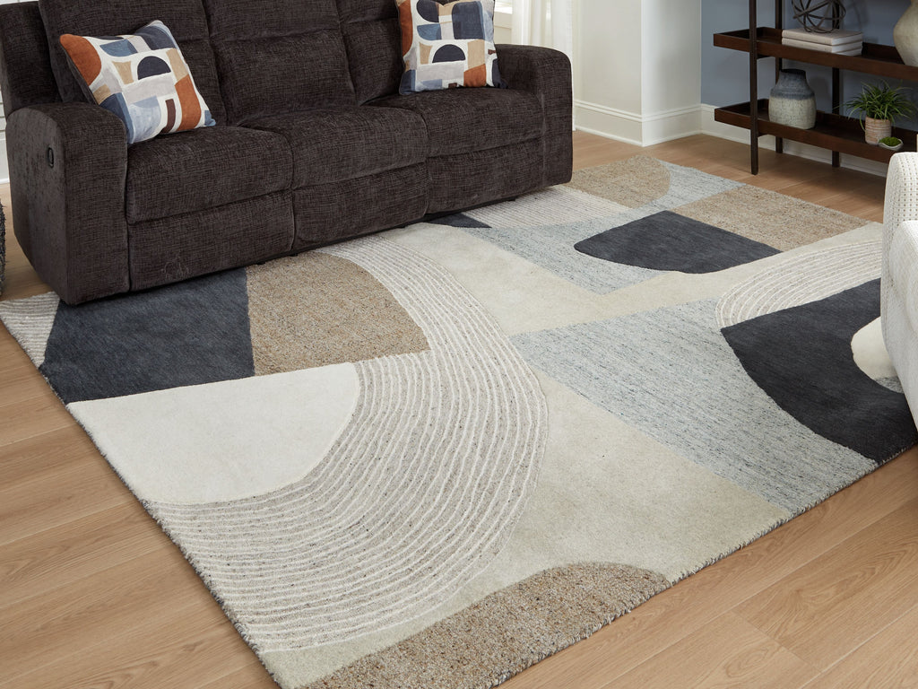 Geometric beige area rug with dark gray and light blue shapes and textured wavy line pattern