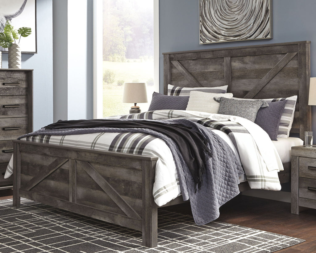 Gray crossbuck panel bed with plaid bedding and pillows