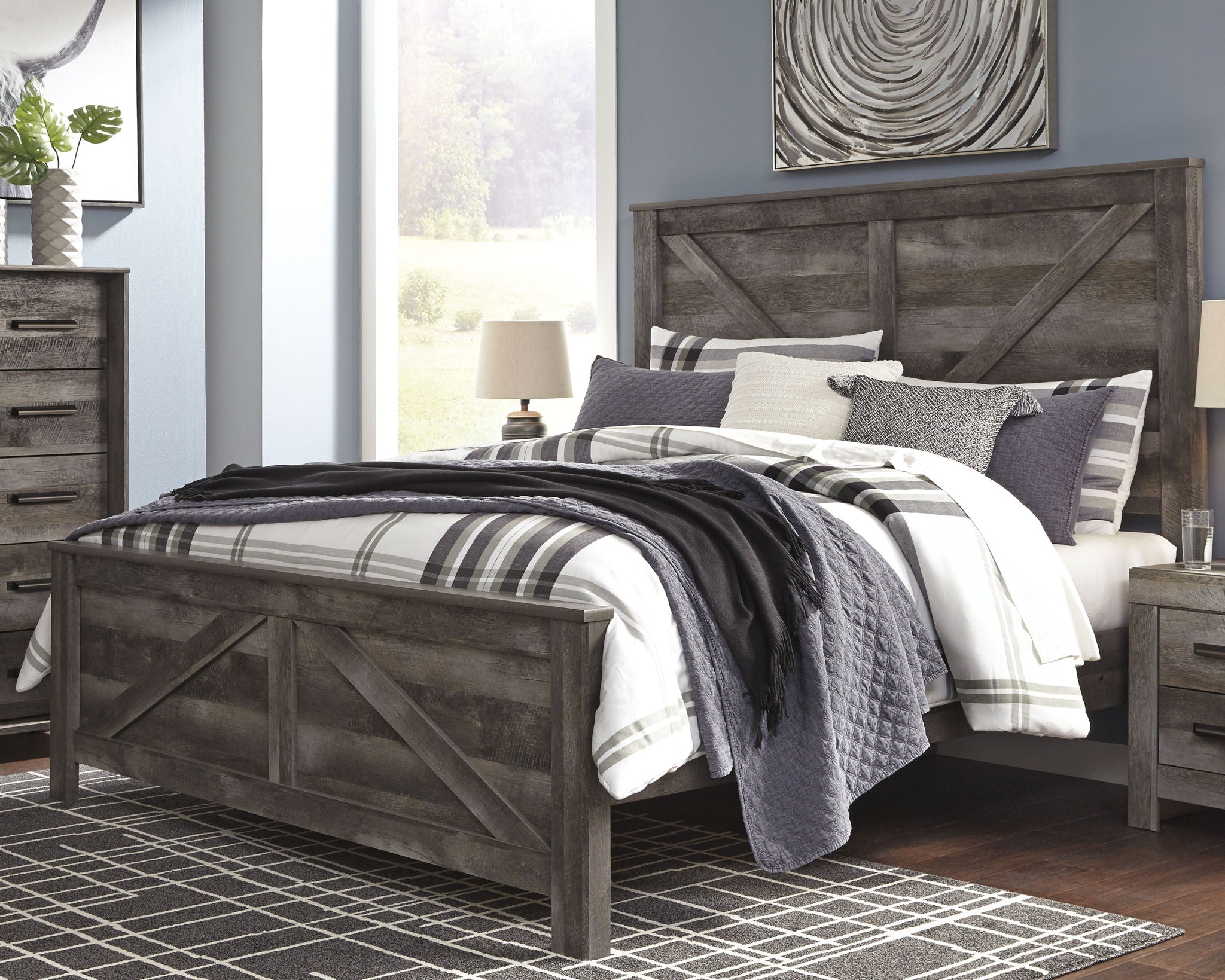 Gray crossbuck panel bed with plaid bedding and pillows
