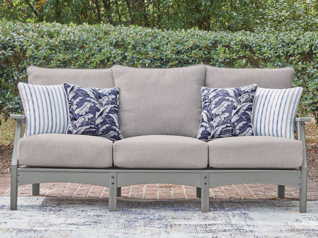 Gray outdoor sofa with center back cushion and blue patterned throw pillows
