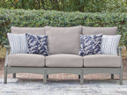 Gray outdoor sofa with center back cushion and blue patterned throw pillows