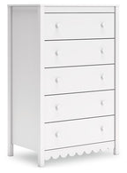 White five-drawer chest with round knob pulls and scalloped base detail