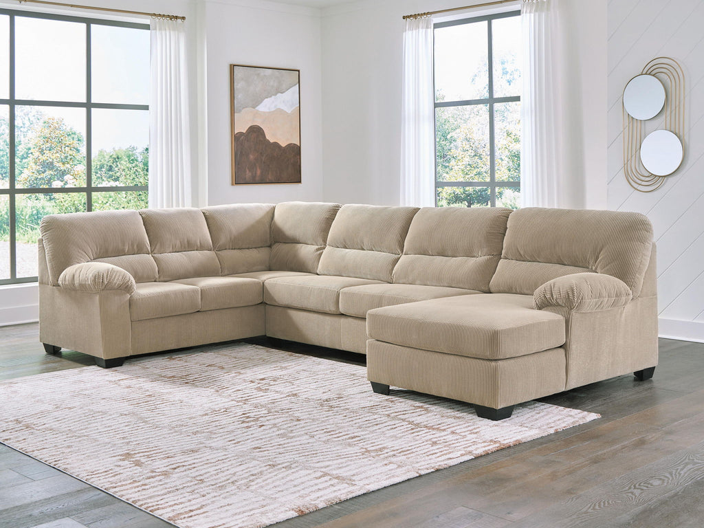 Light beige sectional sofa with corner chaise, tufted cushions, padded ottoman seats