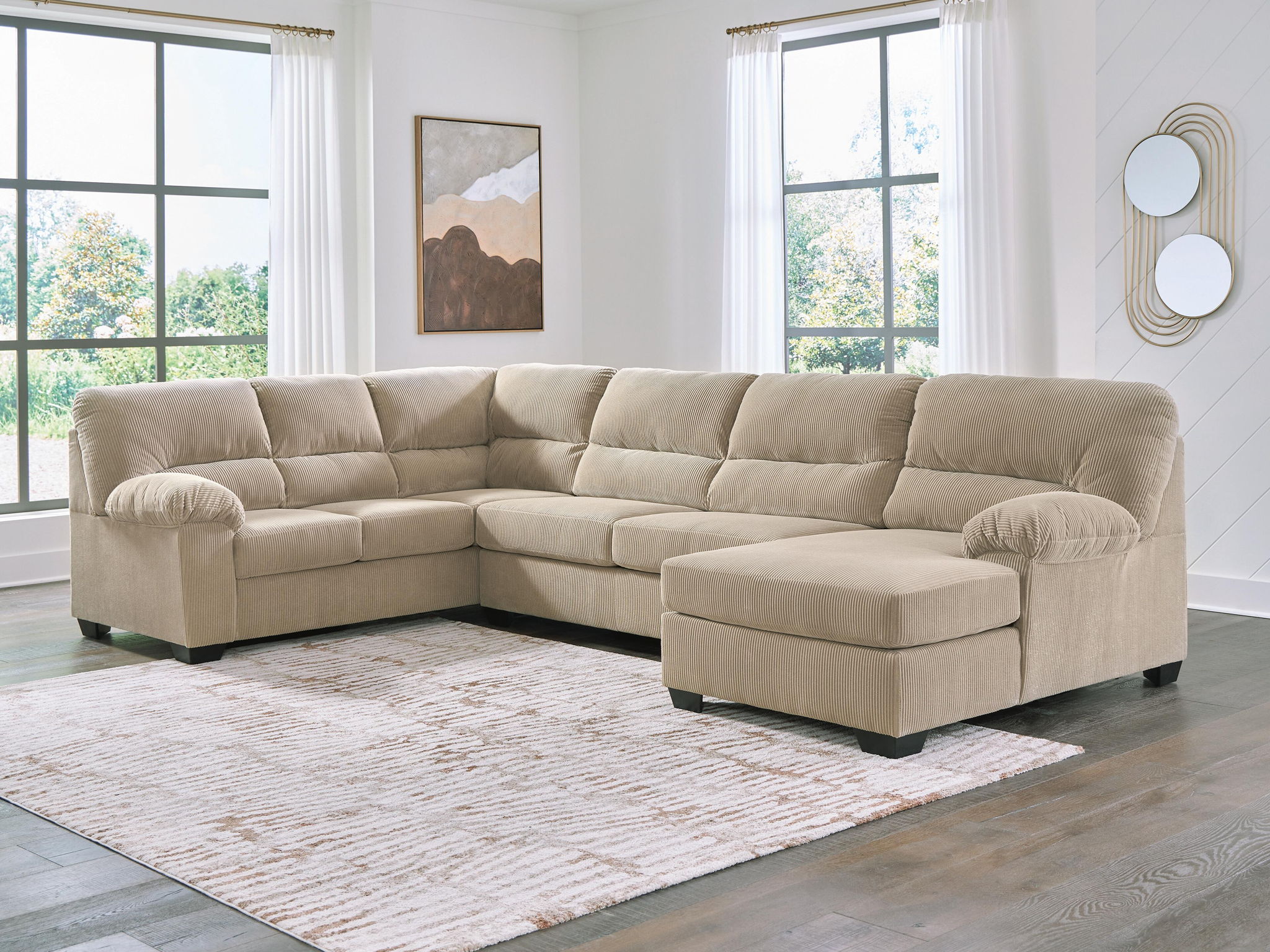 Light beige sectional sofa with corner chaise, tufted cushions, padded ottoman seats