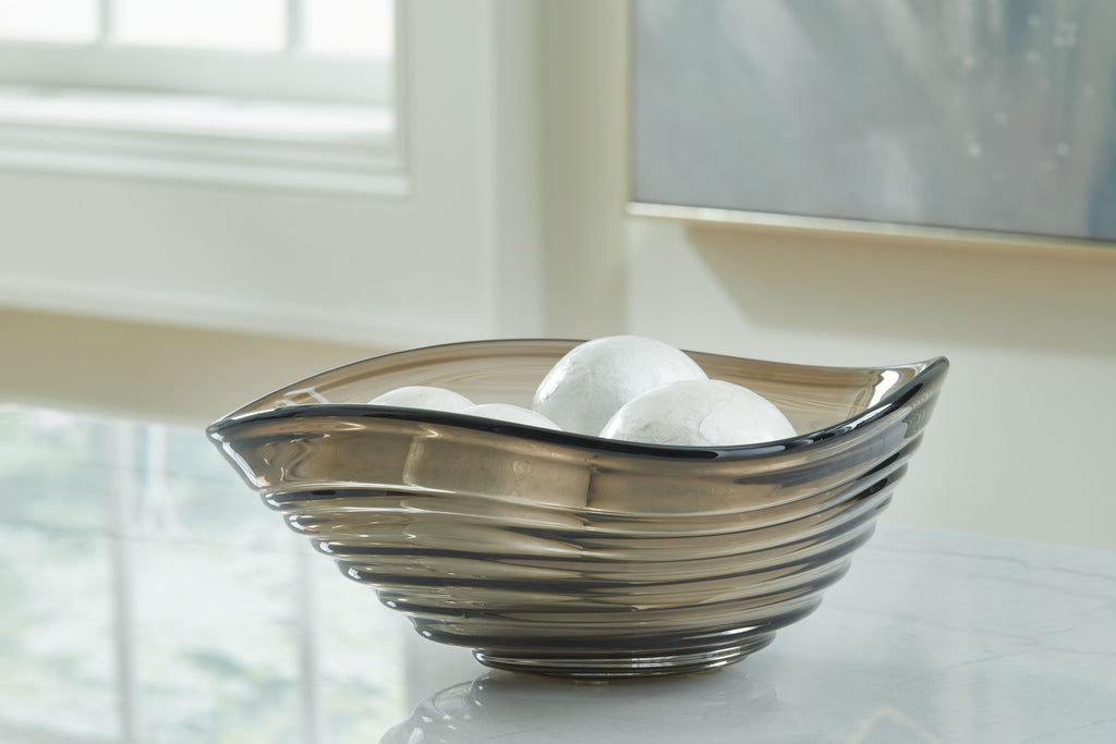 Solariston gray-brown glass bowl holding white decorative spheres, black rim