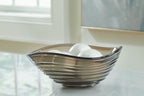 Solariston gray-brown glass bowl holding white decorative spheres, black rim