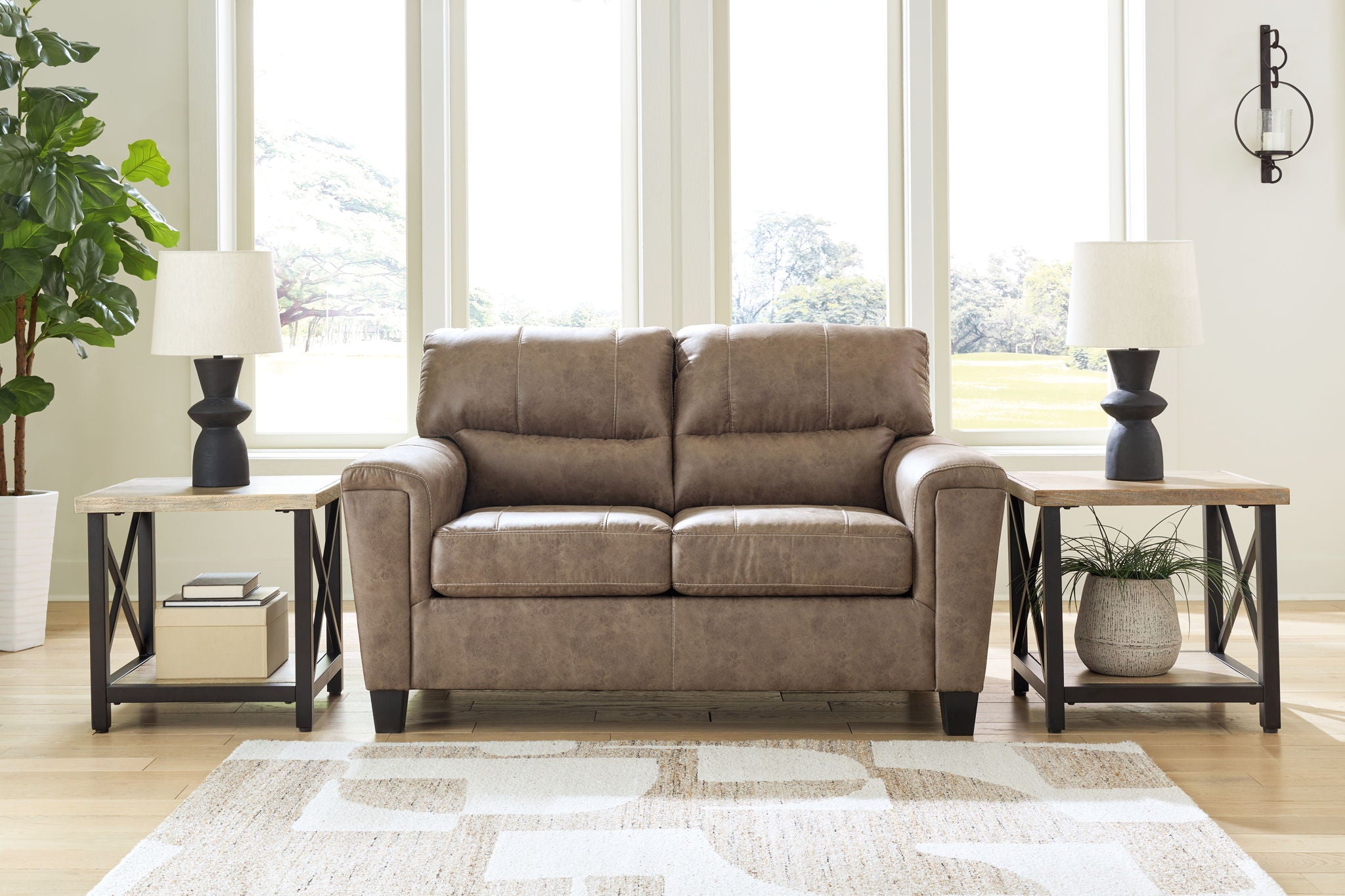 Taupe loveseat with tufted back cushions and padded square arms, dark legs