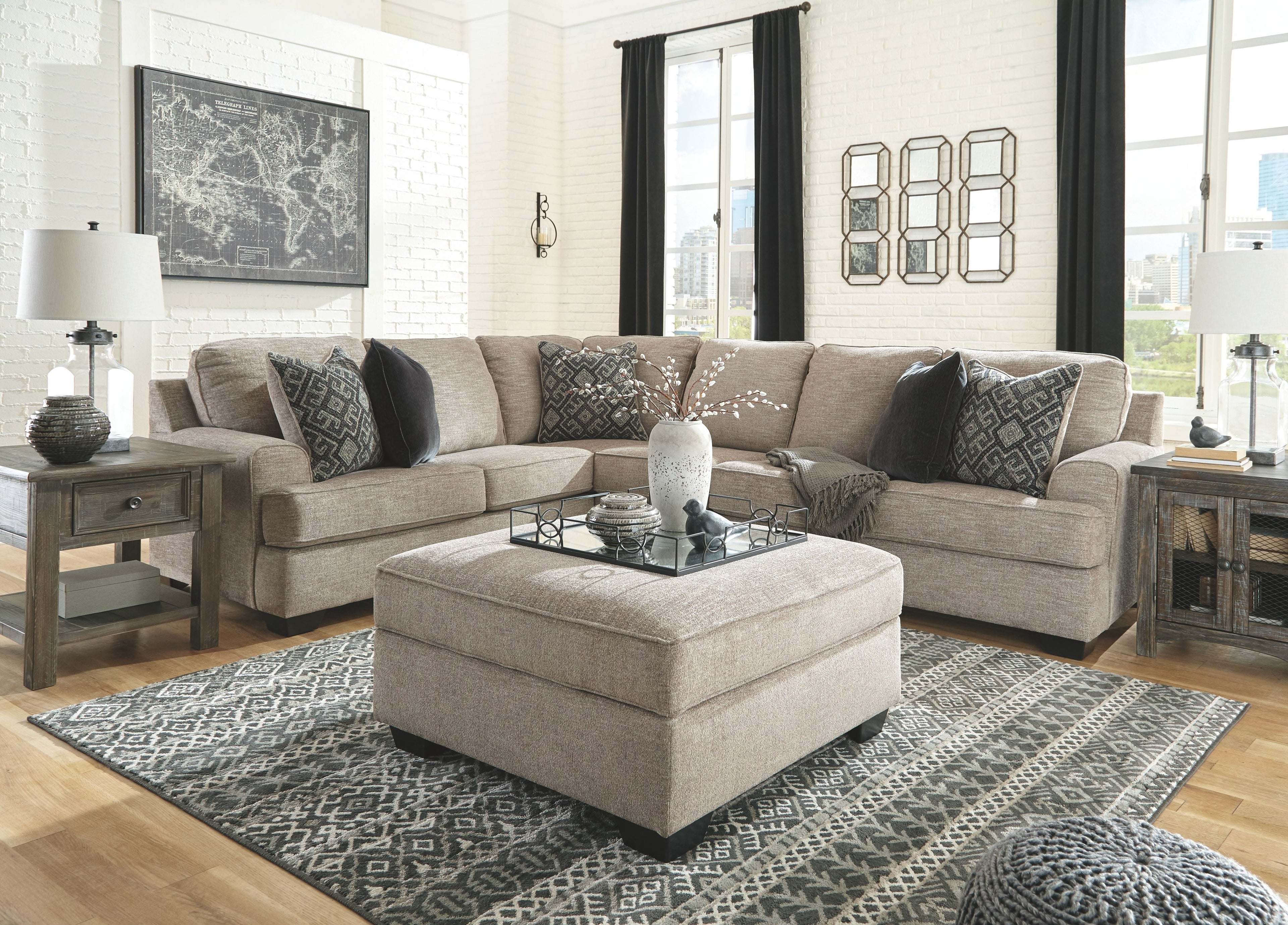 Beige sectional sofa set with center ottoman and geometric accent pillows