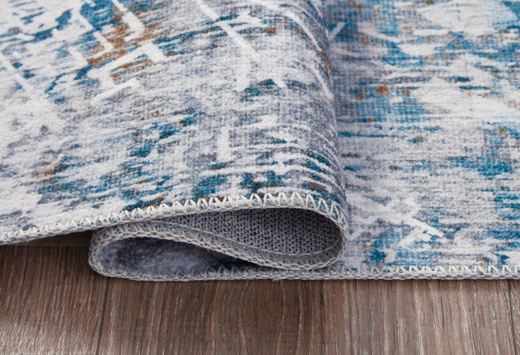 Blue and white rug edge with stitched binding and short pile