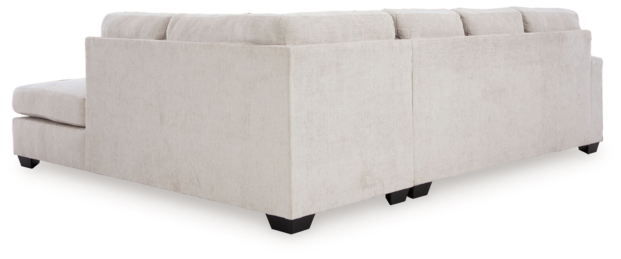 Light beige sectional sofa with boxy arms and cushioned back, corner chaise