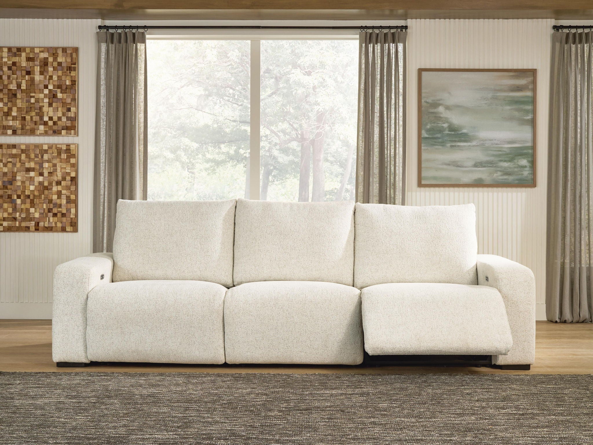 White power reclining sectional sofa with three seat cushions and reclining ottoman panels