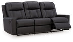 Black reclining sofa with pull-out footrest on the right and tufted seat cushions