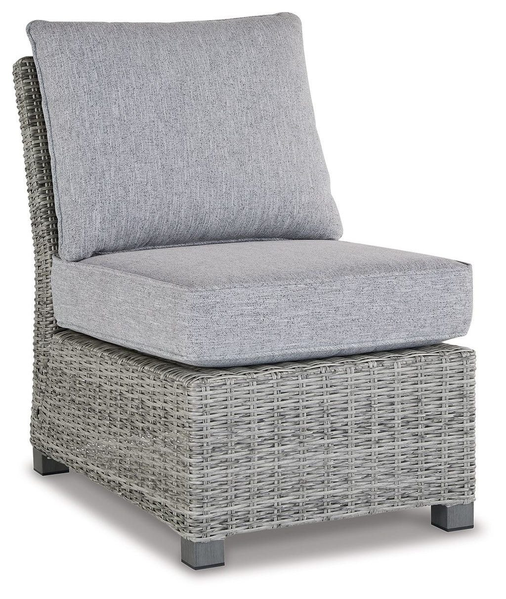 Light gray outdoor sofa chair with wicker base and padded seat