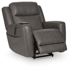Power lift recliner in dark gray faux leather, legrest extended on black base