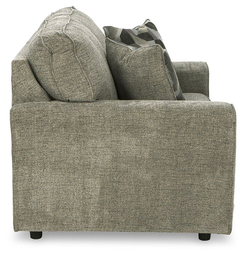 Light gray loveseat side view with wide arms and two geometric throw pillows