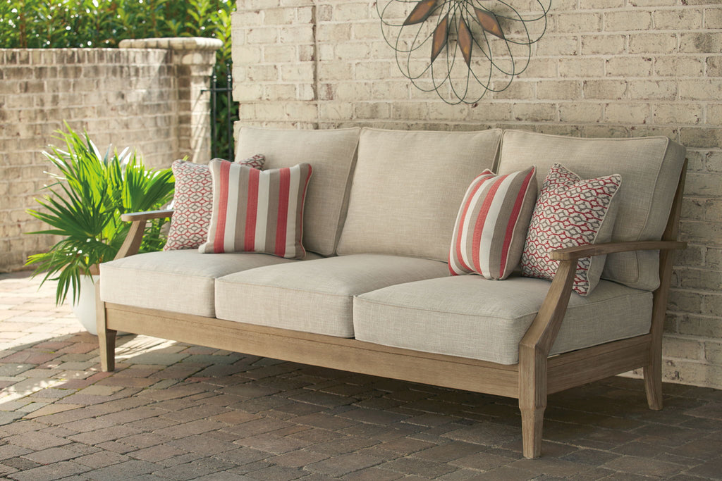 Beige lounge sofa with three-seat cushions and striped patterned pillows