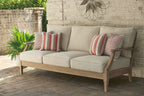 Beige lounge sofa with three-seat cushions and striped patterned pillows