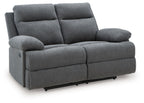Dark gray reclining loveseat with padded armrests and two back cushions