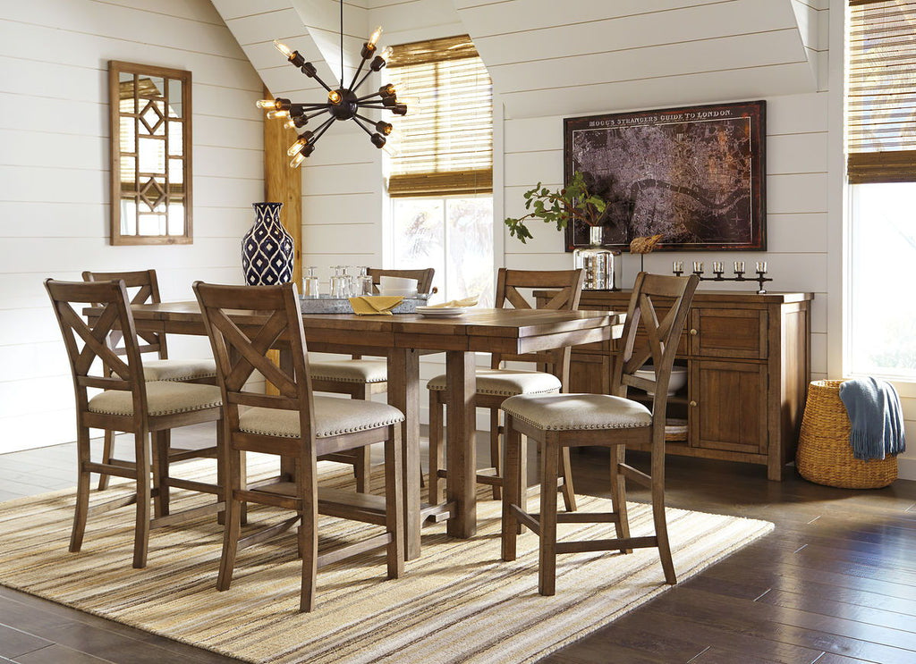 Counter-height dining table set with cushioned stools, cross-back chairs, and dark wood server