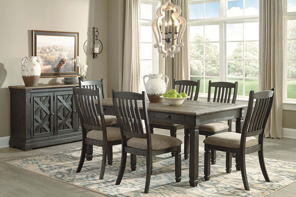 Dark gray dining table with six slat-back chairs and upholstered seat cushions
