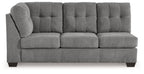Gray tufted-back sofa with three seat cushions, square arms, and dark legs