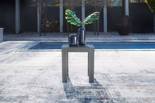 Charcoal gray square end table on four legs with slatted top and open shelf